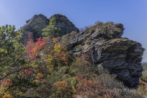 Looking up at one of the Chimneys from the lower trai lsection.  Some autumn colors may be seen in the foliage surrounding this rocky outcrop towering above.